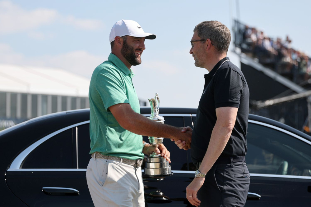 Loňský šampion The Open Scottie Scheffler a ředitel The R&amp;A Mark Darbon (foto: GettyImages).